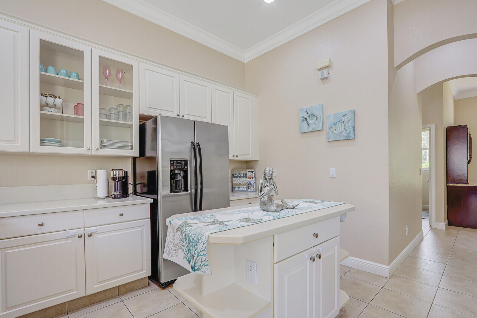 146 Magnolia Way Tequesta, FL 33469 - Photo 23 of 81 a kitchen with a sink and refrigerator