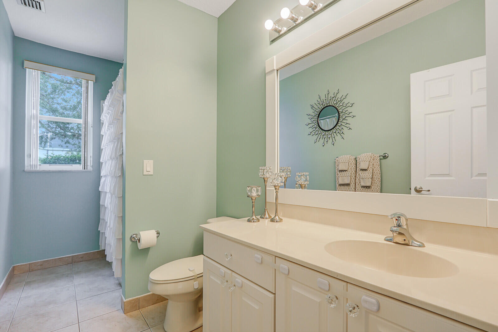 146 Magnolia Way Tequesta, FL 33469 - Photo 49 of 81 a bathroom with a sink a toilet and a mirror