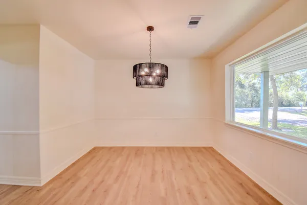 a view of a room with wooden floor and a window