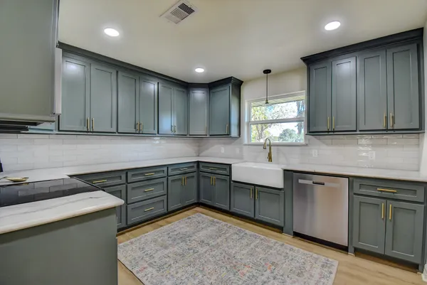 a kitchen with a sink cabinets and window