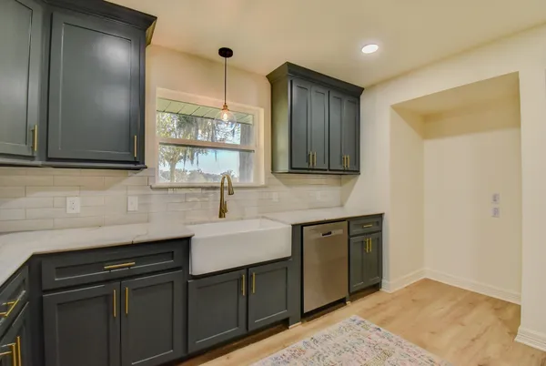 a kitchen with stainless steel appliances granite countertop a sink stove and cabinets