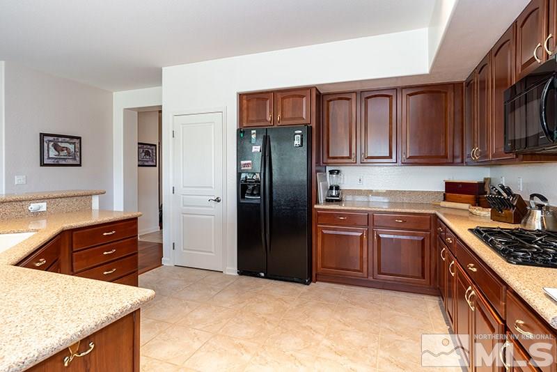1365 Meridian Ranch Drive Reno, NV 89523 - Photo 12 of 18 a kitchen with stainless steel appliances granite countertop a refrigerator stove and sink