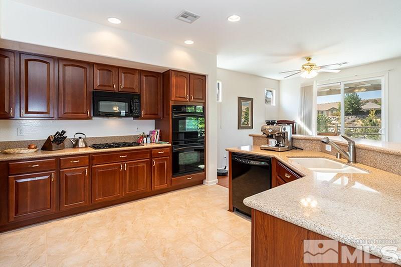 1365 Meridian Ranch Drive Reno, NV 89523 - Photo 3 of 18 a kitchen with stainless steel appliances granite countertop a sink stove and refrigerator