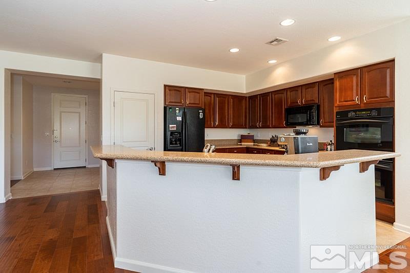 1365 Meridian Ranch Drive Reno, NV 89523 - Photo 10 of 18 a kitchen with stainless steel appliances a refrigerator and a stove top oven