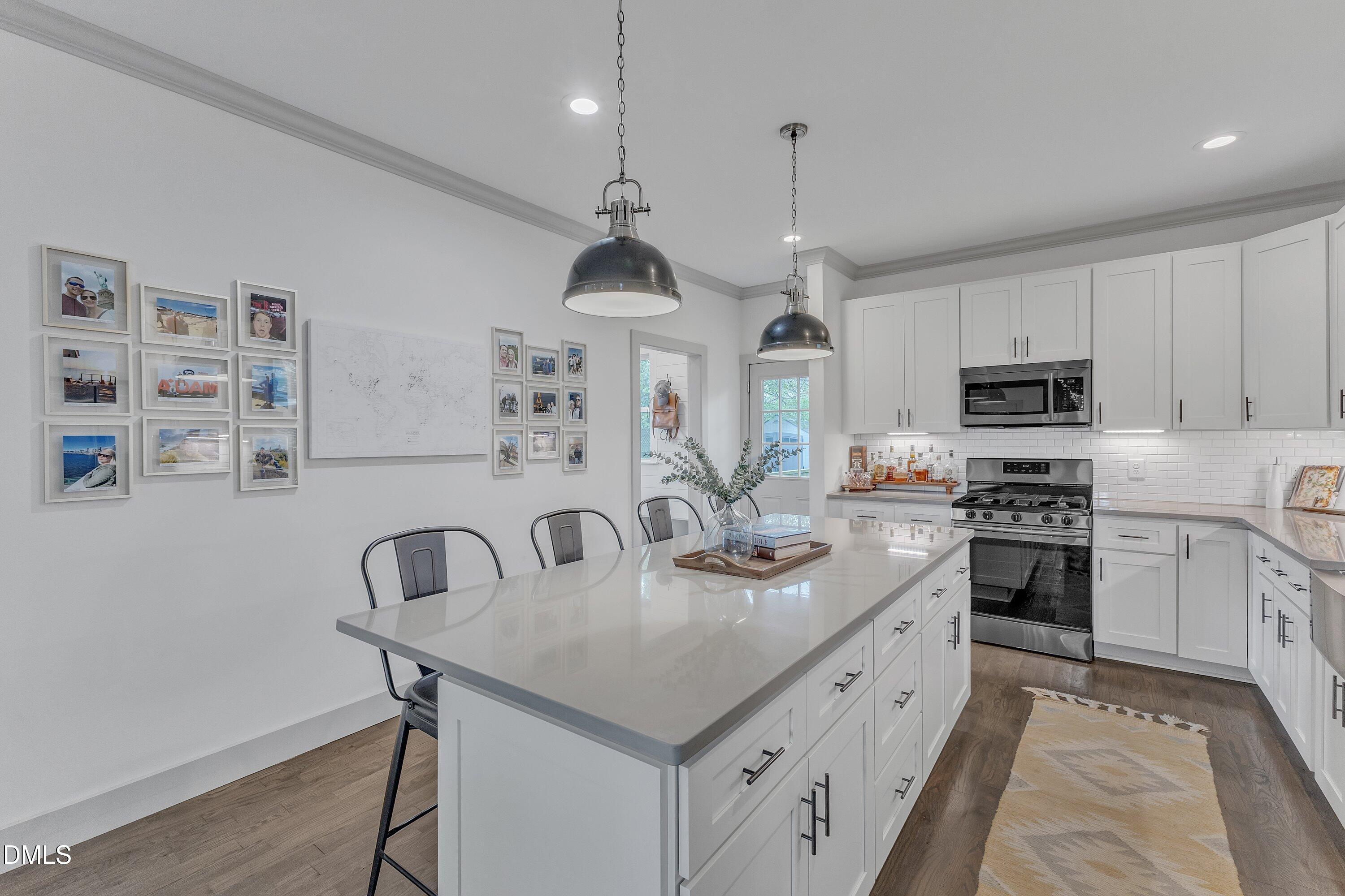 3 Maple Street Raleigh, NC 27610 - Photo 16 of 39 a kitchen with stainless steel appliances granite countertop a sink a stove and a refrigerator