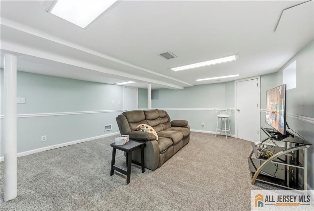 50 3rd Street Fords, NJ 08863 - Photo 26 of 36 a living room with furniture a window and a flat screen tv