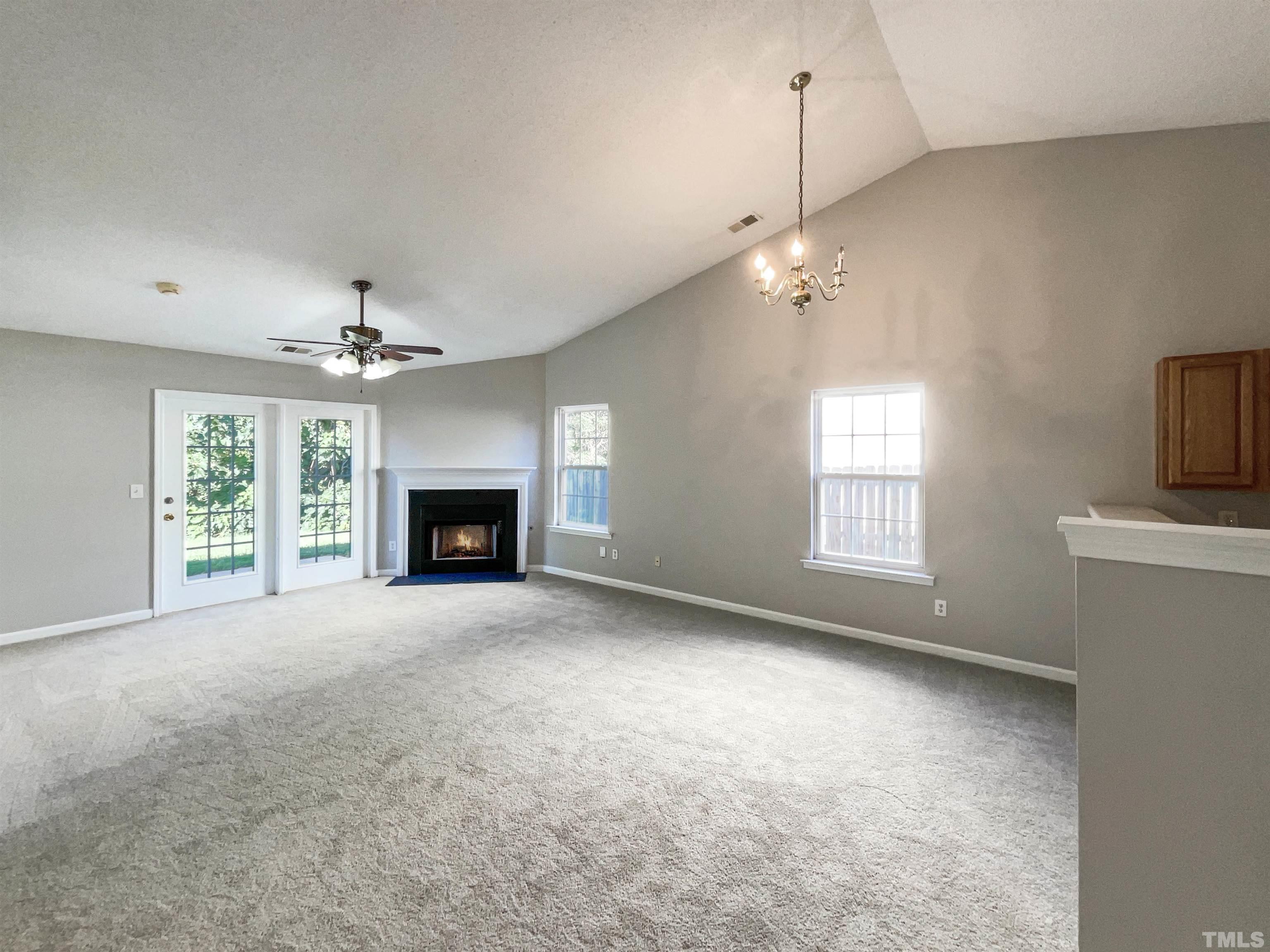 3300 Marcony Way Raleigh, NC 27610 - Photo 3 of 15 a view of empty room with fireplace and windows