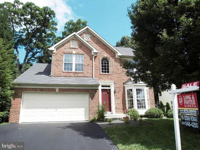 13339 Copper Ridge Road Germantown, MD 20874 - Photo 1 of 20 a front view of a house with a yard and garage