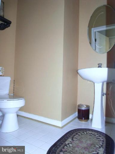 13339 Copper Ridge Road Germantown, MD 20874 - Photo 12 of 20 a bathroom with a toilet and a mirror