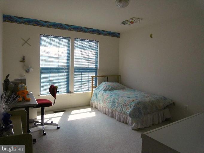 13339 Copper Ridge Road Germantown, MD 20874 - Photo 16 of 20 a living room with a bed furniture and a window