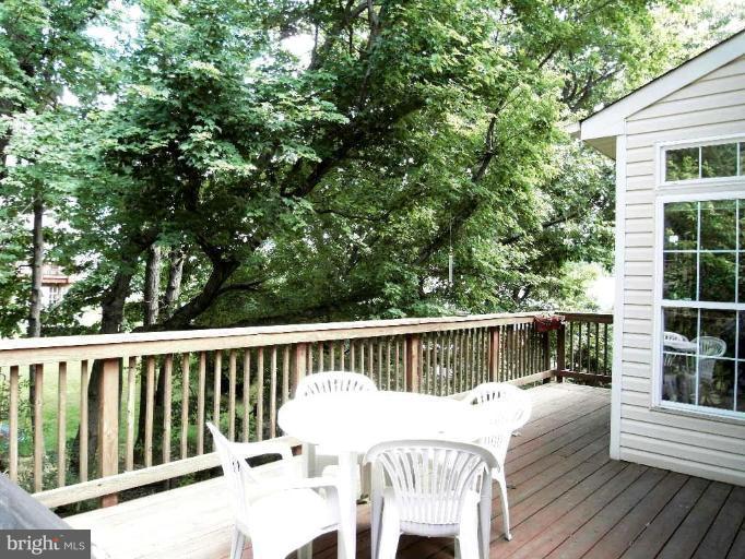 13339 Copper Ridge Road Germantown, MD 20874 - Photo 19 of 20 a view of a deck with two chair and wooden floor