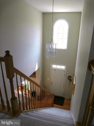 13339 Copper Ridge Road Germantown, MD 20874 - Photo 7 of 20 a view of staircase with railing and wooden floor