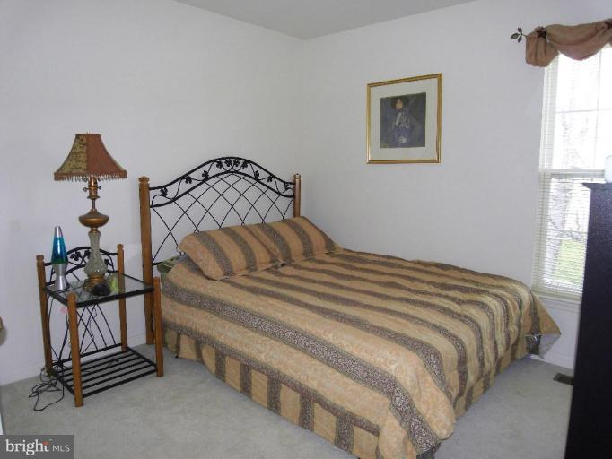 13339 Copper Ridge Road Germantown, MD 20874 - Photo 8 of 20 a bedroom with a bed and a window