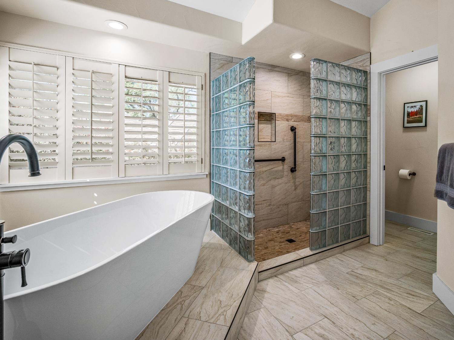 4032 Vega Loop Shingle Springs, CA 95682 - Photo 24 of 44 a bathroom with a bathtub and a shower