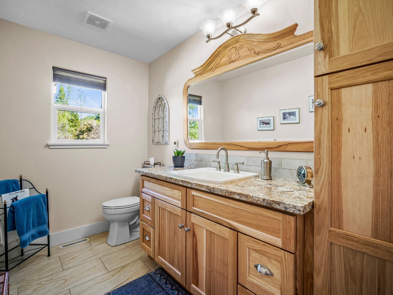 4032 Vega Loop Shingle Springs, CA 95682 - Photo 28 of 44 a bathroom with a granite countertop toilet sink and mirror