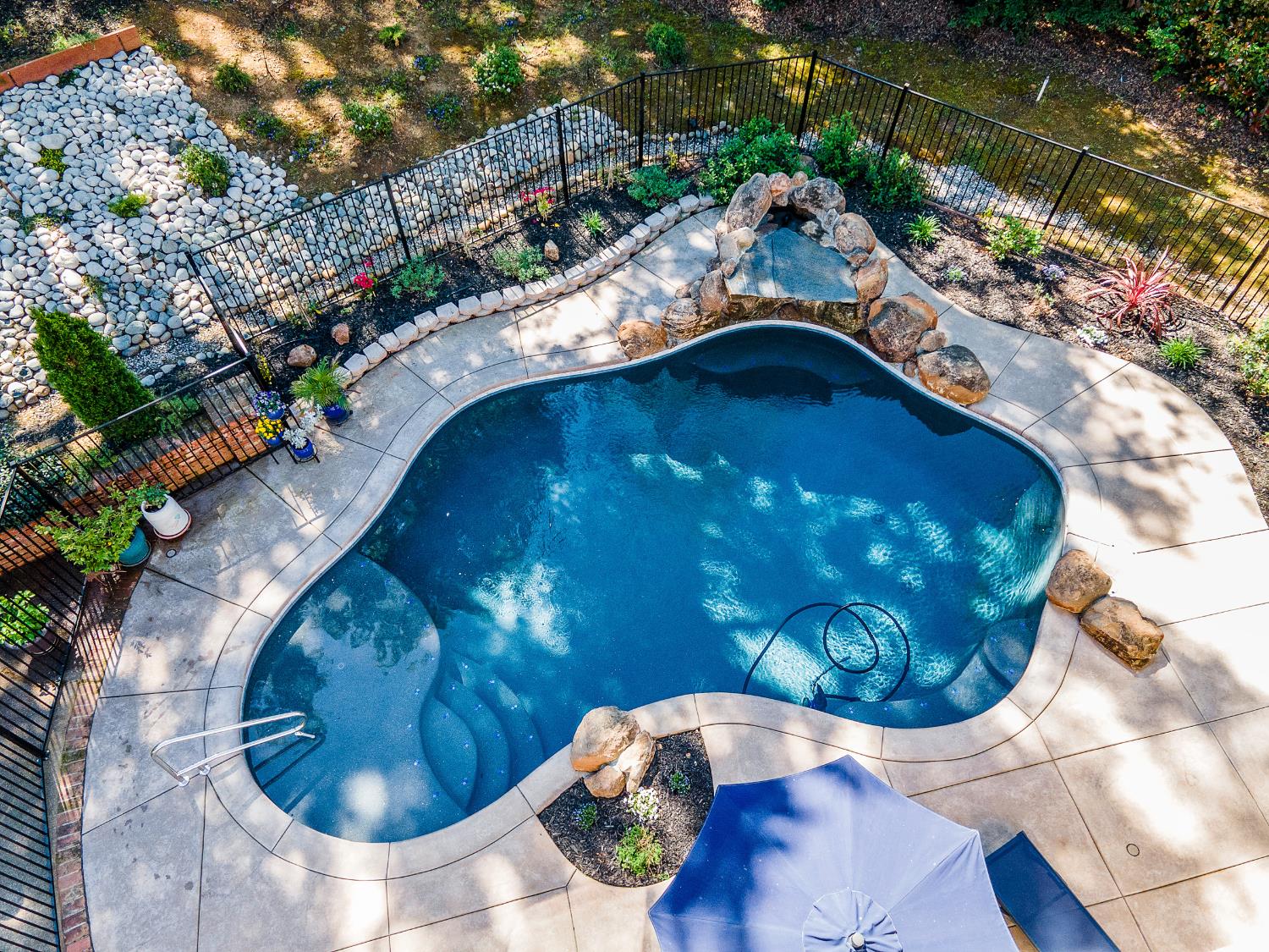 4032 Vega Loop Shingle Springs, CA 95682 - Photo 33 of 44 a view of swimming pool in a backyard