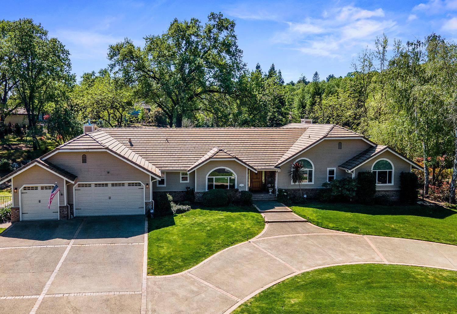 4032 Vega Loop Shingle Springs, CA 95682 - Photo 37 of 44 a view of house with garden and tall tress