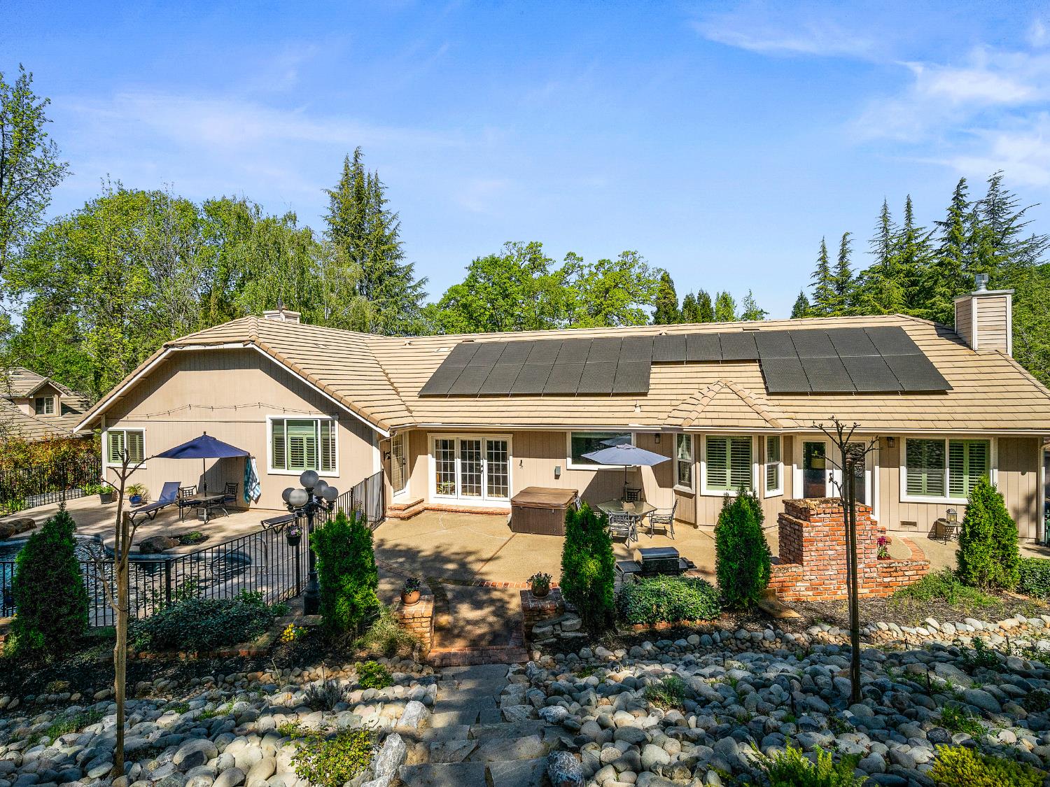 4032 Vega Loop Shingle Springs, CA 95682 - Photo 38 of 44 a view of a white house with a big yard and potted plants