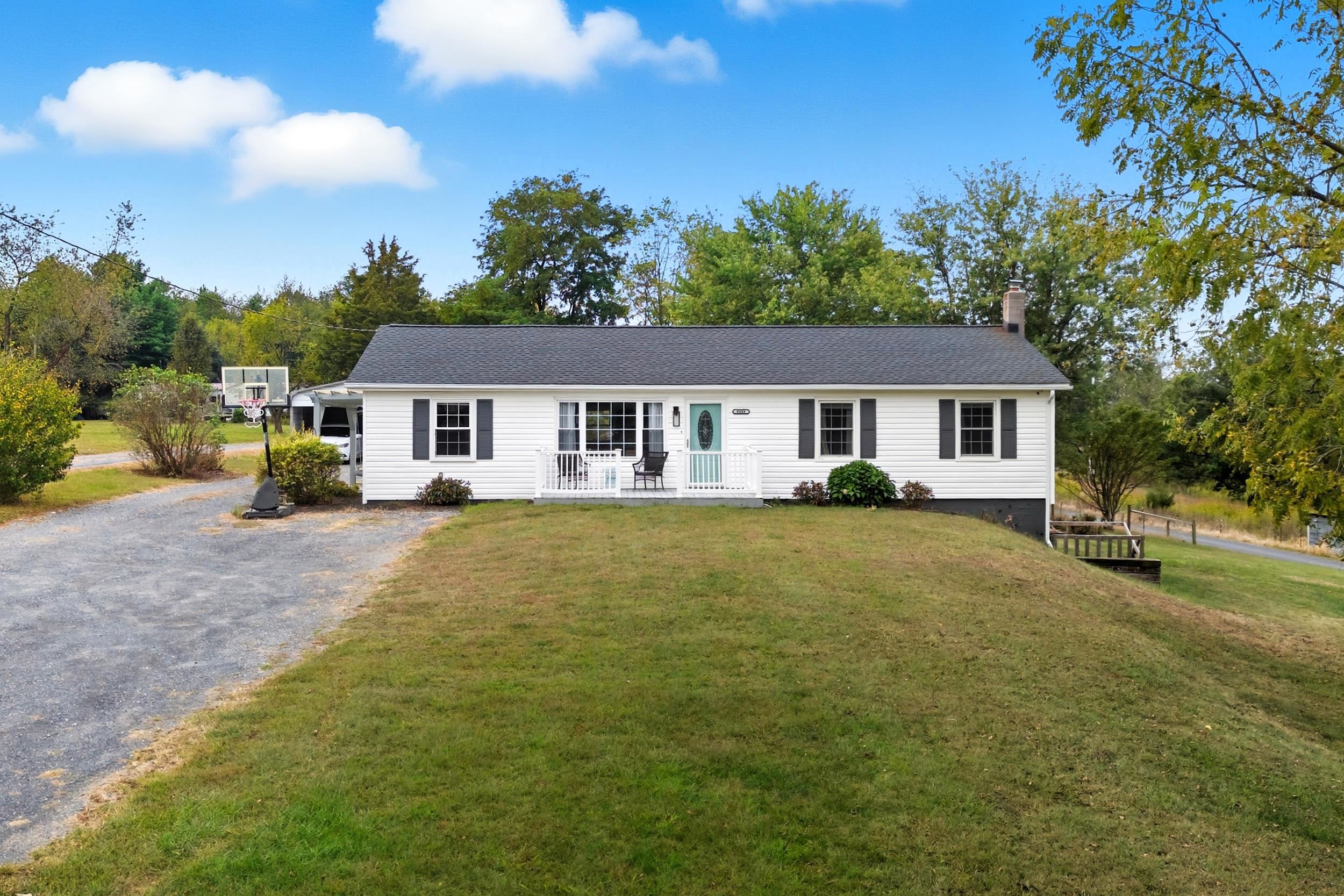 a front view of a house with a garden