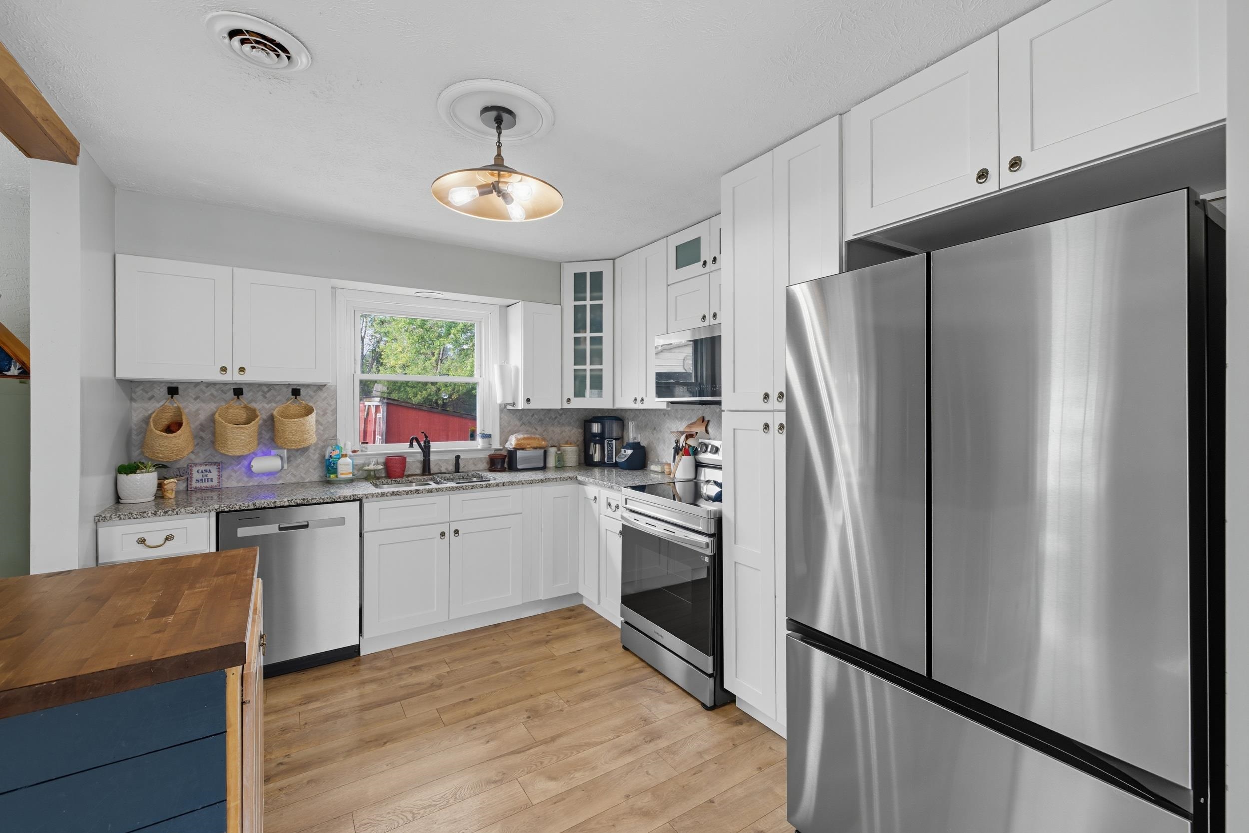8449 Indian Trail Road Harrisonburg, VA 22802 - Photo 3 of 75 a kitchen with white cabinets and stainless steel appliances