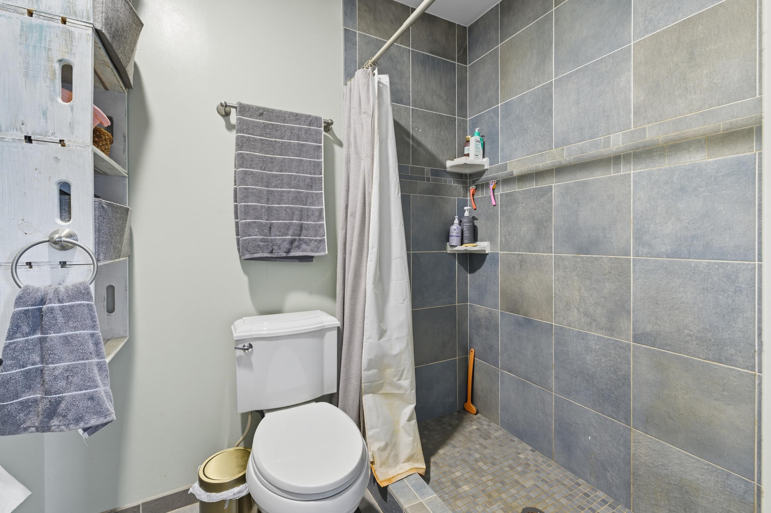 8449 Indian Trail Road Harrisonburg, VA 22802 - Photo 31 of 75 a white toilet sitting next to a bathroom sink and a shower