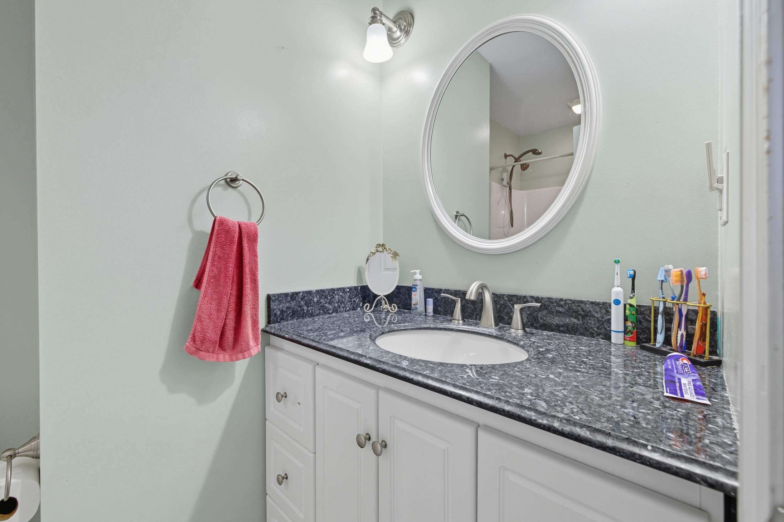 8449 Indian Trail Road Harrisonburg, VA 22802 - Photo 36 of 75 a bathroom with a granite countertop sink and a mirror