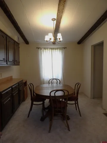 a view of a a dining room with furniture window and wooden floor