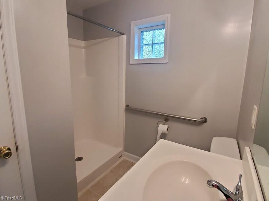 2207 Lane Road Greensboro, NC 27408 - Photo 11 of 19 The master bath has a walk in shower.