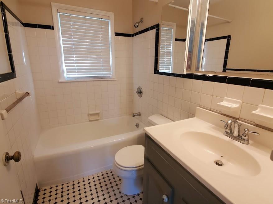 2207 Lane Road Greensboro, NC 27408 - Photo 14 of 19 This 50's vibe bath is really cute. Tile on floor and surround is in good condition.
