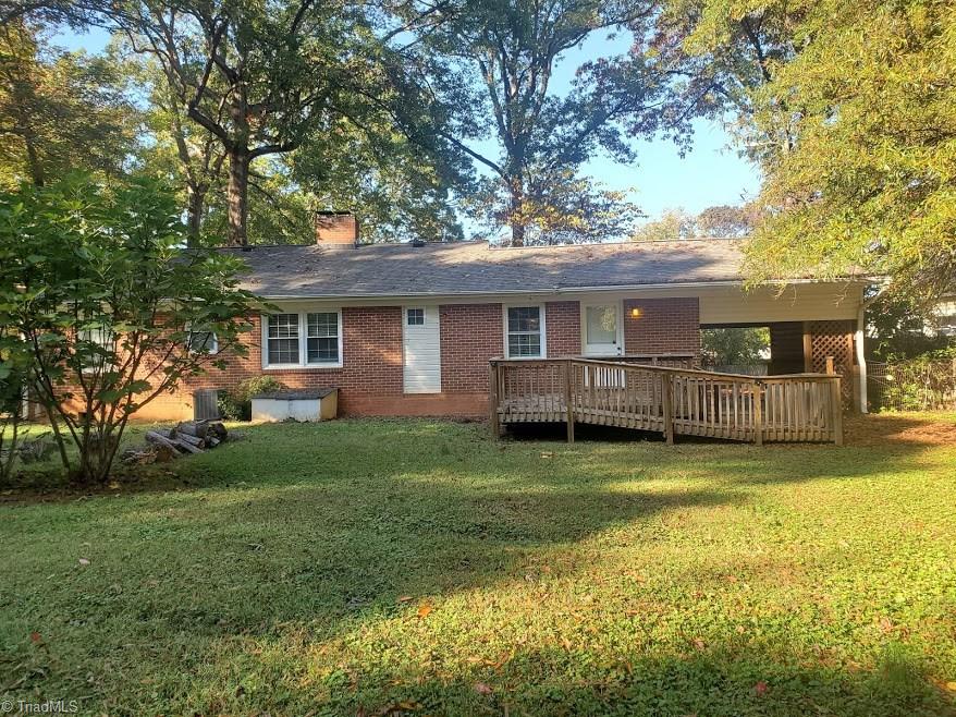 2207 Lane Road Greensboro, NC 27408 - Photo 15 of 19 This is a shot of the back of the house. The "box" under the double windows is service access to the crawl space.
