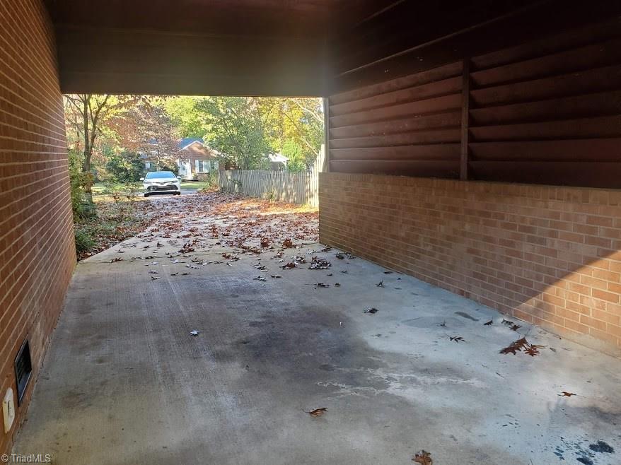 2207 Lane Road Greensboro, NC 27408 - Photo 16 of 19 From the carport you can access the deck and right into the kitchen, or use the walk to the front door.