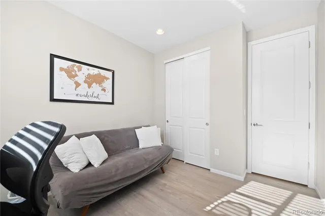 a view of a livingroom with workspace and a couch