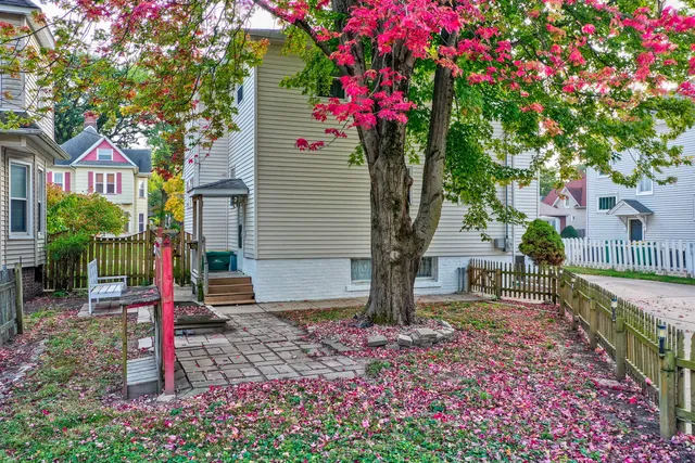 a front view of a house with a garden