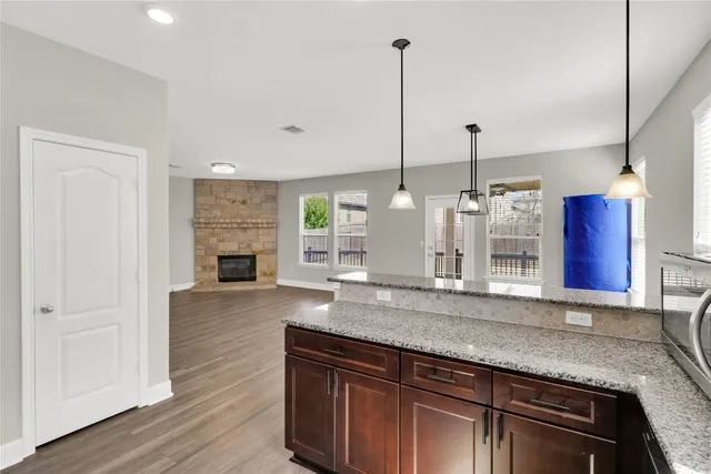 a kitchen with stainless steel appliances granite countertop a granite counter tops and a wooden floors