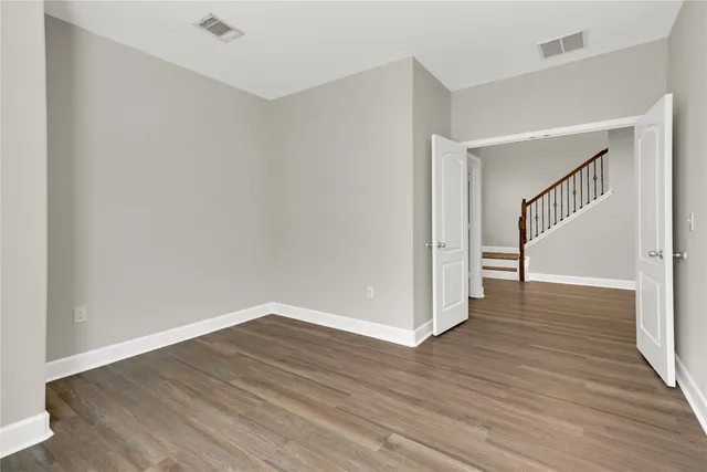 a view of a hallway with wooden floor