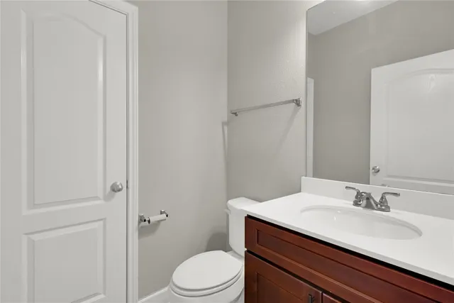 a bathroom with a granite countertop sink toilet a mirror and shower