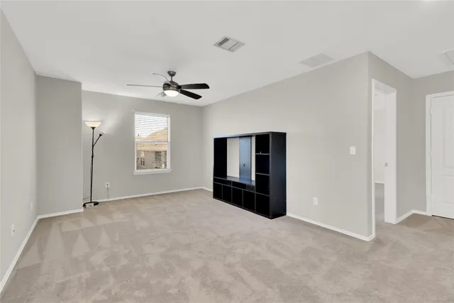 a view of a livingroom with a ceiling fan and window