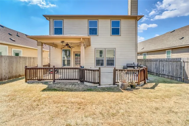 a view of a house with wooden fence
