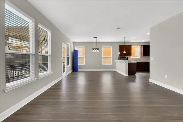 a view of a livingroom with furniture wooden floor and window
