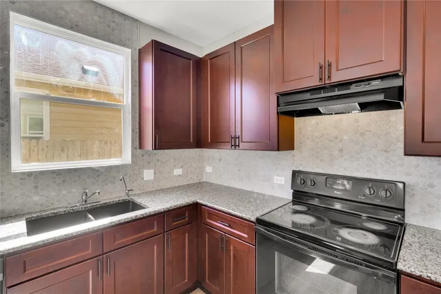 a kitchen with a sink and cabinets