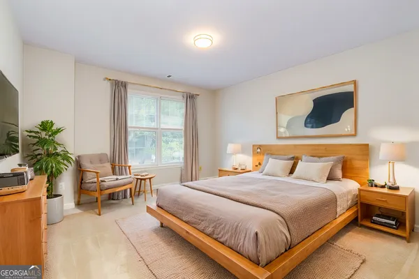 a bedroom with a bed and a window