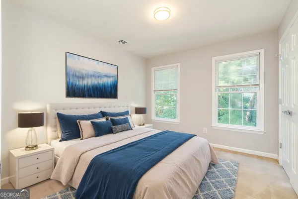 a bedroom with a large bed and a window