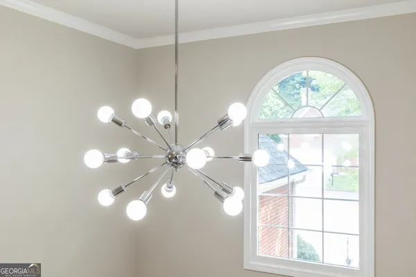a view of a big room with wooden floor fan and windows