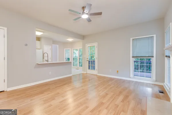 a view of an empty room with window and fire place