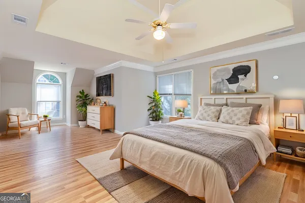 a bedroom with a bed and wooden floor
