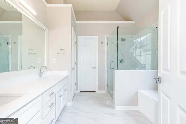 a spacious bathroom with a tub sink and shower
