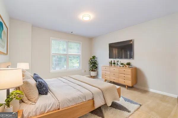 a bedroom with a bed and a flat screen tv