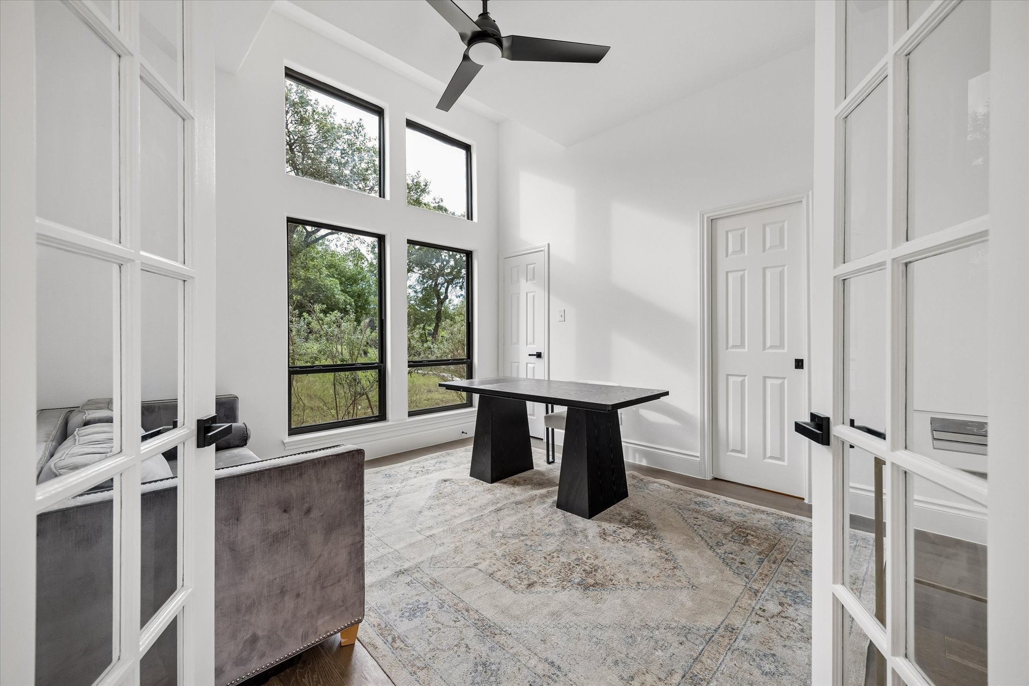 3719 Bee Creek Road Spicewood, TX 78669 - Photo 17 of 40 Tall windows and French doors introduce abundant natural light into this versatile office space.
