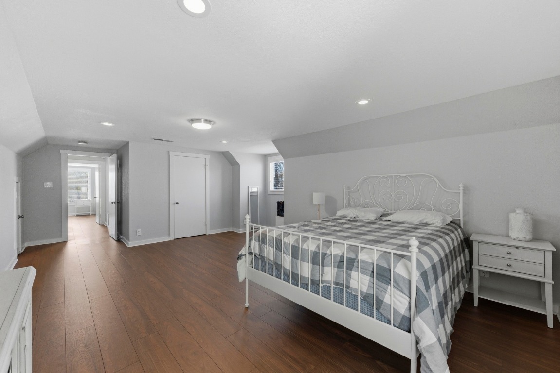 1801 Ohlen Road Austin, TX 78757 - Photo 17 of 29 a bedroom with a bed and a view of kitchen