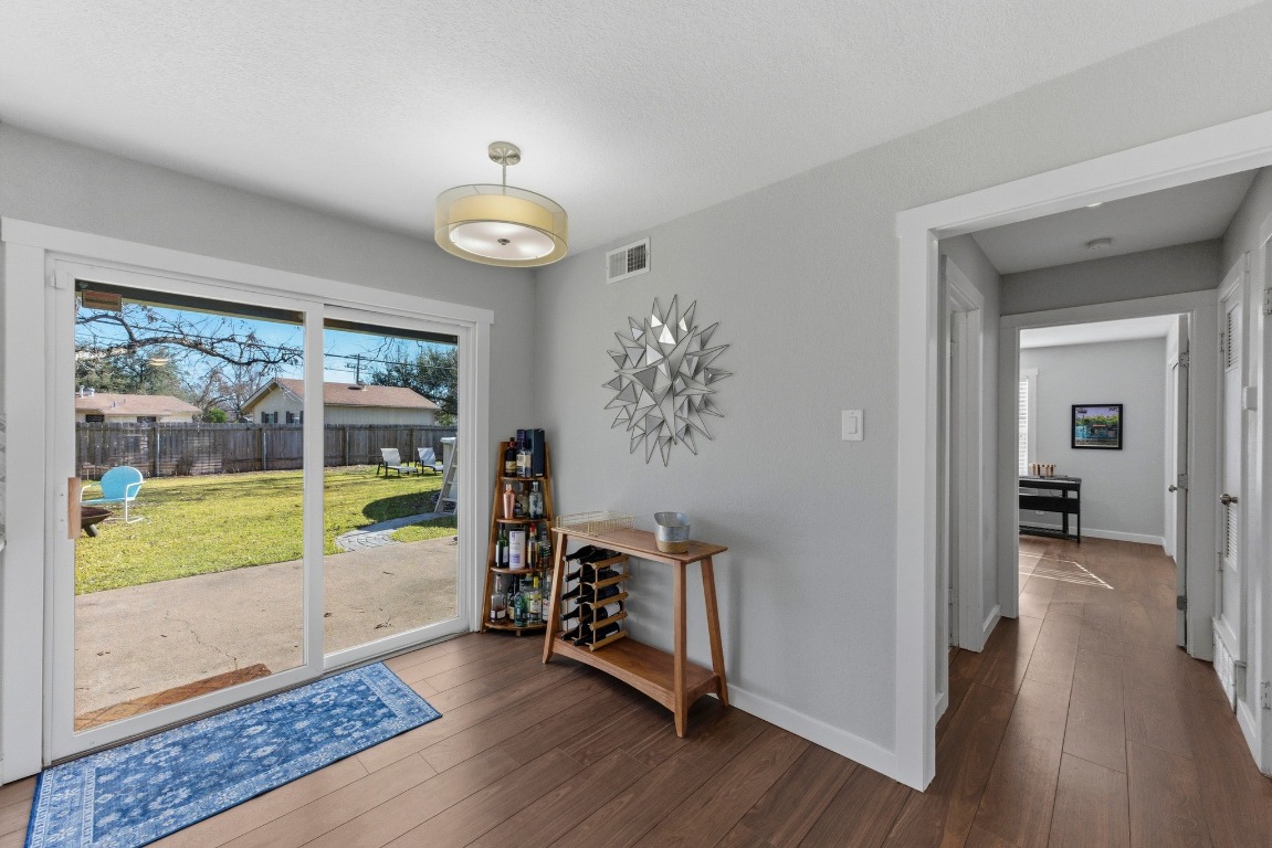 1801 Ohlen Road Austin, TX 78757 - Photo 10 of 29 a view of a hallway with wooden floor and windows